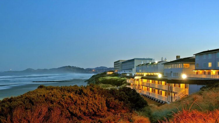 Seagrass Oceanfront Inn erear exterior beside the beach during the evening